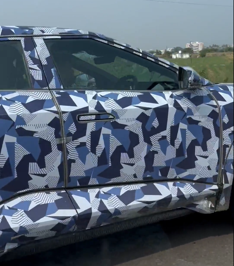 Futuristic design of Mahindra BE 6e with connected LED lights and coupe-style roofline